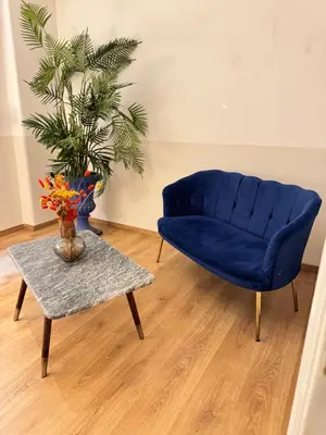 a blue couch and a table in a living room at SIS Urban Apartments in Athens