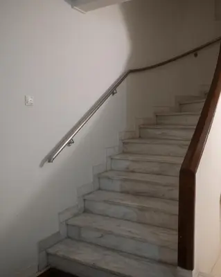 a staircase with a metal handrail and concrete steps at SIS Urban Apartments in Athens