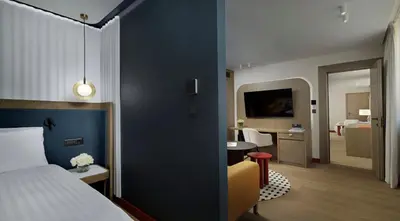 a hotel room with a bed and a living room at Athenaeum Intercontinental by IHG in Athens