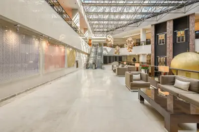 a large lobby with couches and tables in a building at Athenaeum Intercontinental by IHG in Athens