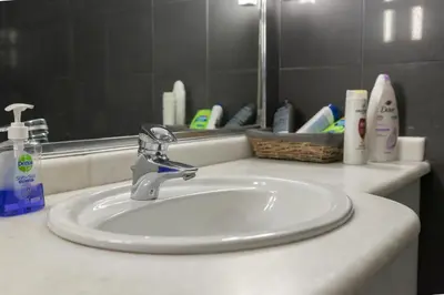a bathroom counter with a sink and a mirror at The heart of Plaka in Athens