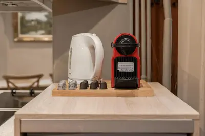 a red blender sitting on top of a kitchen counter at The heart of Plaka in Athens