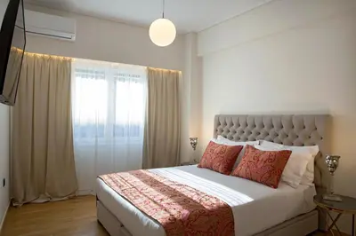 a bedroom with a large bed and a window at La Residence Athens in Athens