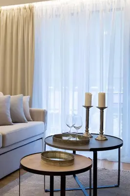 a living room with two tables and a couch at La Residence Athens in Athens