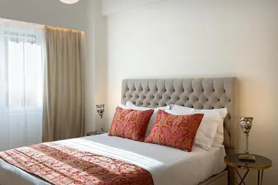 a bedroom with a large bed with red pillows at La Residence Athens in Athens
