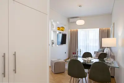 a living room with a dining room table and chairs at La Residence Athens in Athens