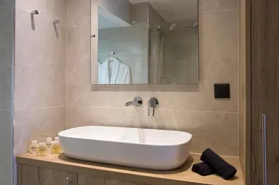 a bathroom with a white sink and a mirror at La Residence Athens in Athens