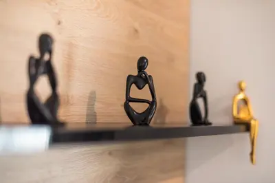 a shelf with figurines of people on it at Comfy and modern apartment in Athens