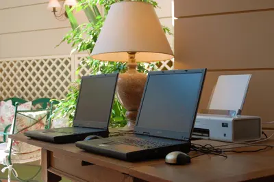 two laptop computers sitting on a desk with a lamp at Philippos Hotel in Athens
