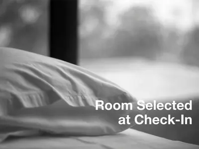 a pillow sitting on a bed with the words room selected at check in at Philippos Hotel in Athens