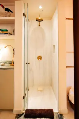 a walk in shower in a small room at Herodion Hotel in Athens