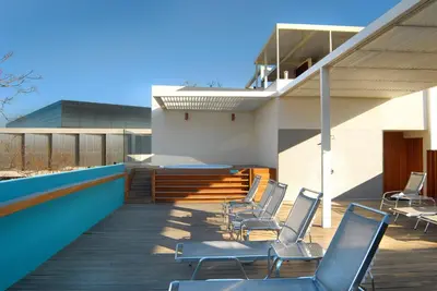 a group of chairs sitting on a wooden deck at Herodion Hotel in Athens