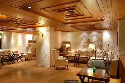 a lobby with couches and tables and chairs at Herodion Hotel in Athens