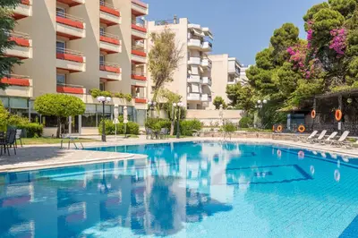 a swimming pool in front of a building at Oasis Hotel Apartments in Athens