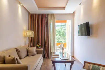 a living room with a couch and a window at Oasis Hotel Apartments in Athens