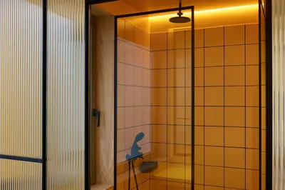 a bathroom with a shower with a toilet in it at DWELL - Elegant City Stay in Athens