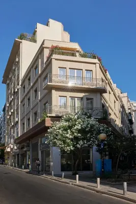 a tall white building on the side of a street at DWELL - Elegant City Stay in Athens
