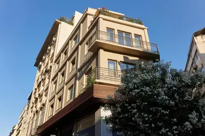 a tall building with a balcony on top of it at DWELL - Elegant City Stay in Athens