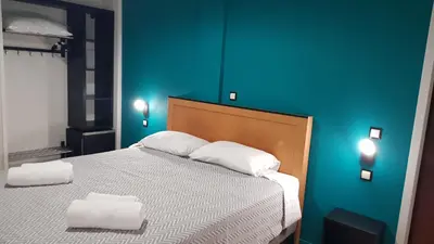 a bedroom with a bed with two towels on it at Savoy Hotel in Piraeus