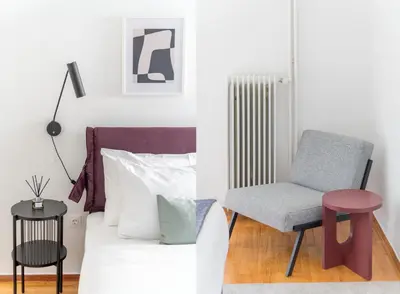 a living room with a chair and a bed at Outstanding 2BR Apartment in Cholargos by UPSTREET in Athens