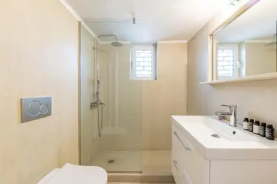 a bathroom with a shower and a toilet and a sink at Outstanding 2BR Apartment in Cholargos by UPSTREET in Athens