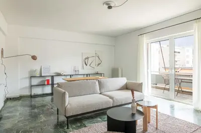 a living room with a couch and a table at Outstanding 2BR Apartment in Cholargos by UPSTREET in Athens