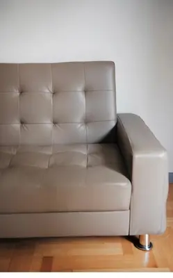 a brown leather couch sitting in a living room at Modern 55m2 Centrally located flat in Athens