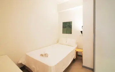 a small white room with a bed in it at Modern 55m2 Centrally located flat in Athens