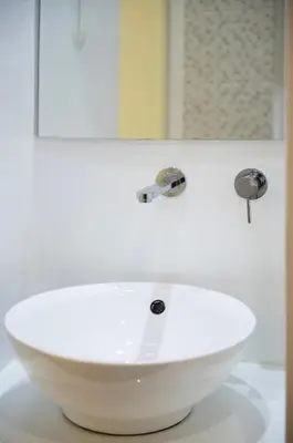 a white sink in a bathroom with a mirror at Modern 55m2 Centrally located flat in Athens