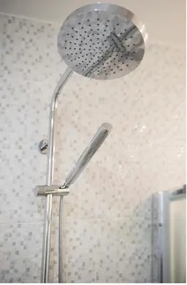 a shower head in a shower stall in a bathroom at Modern 55m2 Centrally located flat in Athens
