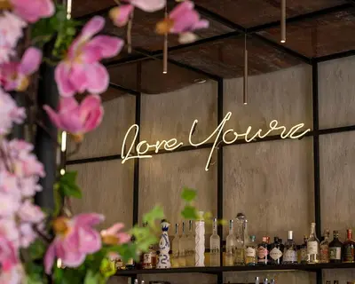 a sign that says love yourself on a wall at Metropolis A2 - Υπέροχη ανακαινισμένη Σουίτα in Athens