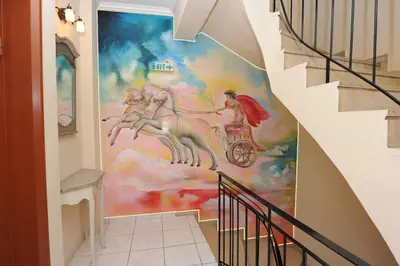 a hallway with a mural of a horse on the wall at Pergamos Hotel in Athens