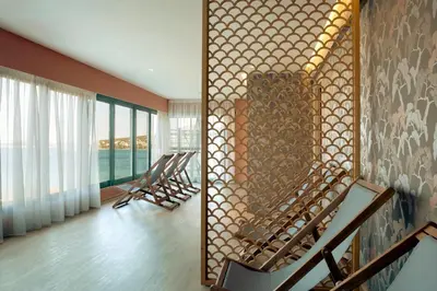 a room with a wall with a patterned wall at Zeus Dolce by Wyndham Athens in Vravrona