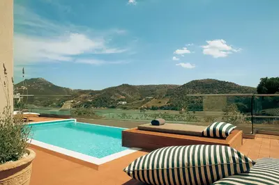 a swimming pool with a view of a mountain at Zeus Dolce by Wyndham Athens in Vravrona