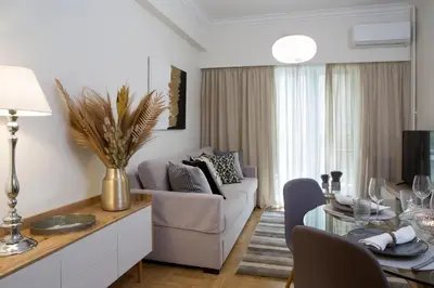 a living room with a couch and a table at Warm & Coozy Residence in Athens