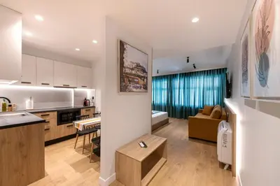 a kitchen and a living room with a couch at A&N Athens Luxury Apartments - Ermou in Athens
