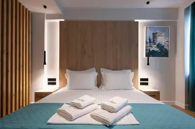 a bedroom with a bed with two towels on it at A&N Athens Luxury Apartments - Ermou in Athens