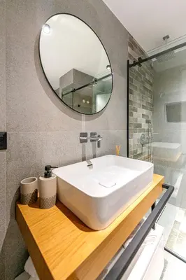 a bathroom with a white sink and a mirror at A&N Athens Luxury Apartments - Ermou in Athens