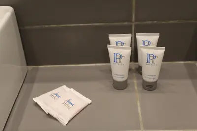 a group of three tubes of sunscreen sitting on a counter at Galaxy Hotel in Athens