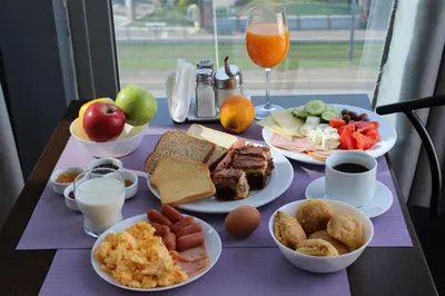 a table with plates of breakfast food on it at Galaxy Hotel in Athens
