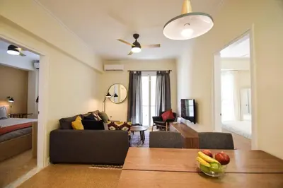 a living room with a couch and fruit on the floor at Pericles Penthouse *Parthenon View* Center in Athens