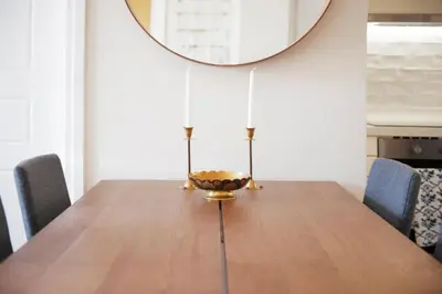 a dining room with a wooden table and a mirror at Pericles Penthouse *Parthenon View* Center in Athens
