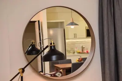 a mirror hanging on a wall next to a living room at Pericles Penthouse *Parthenon View* Center in Athens