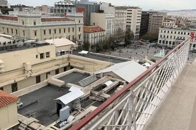an overhead view of a city with buildings at Pericles Penthouse *Parthenon View* Center in Athens