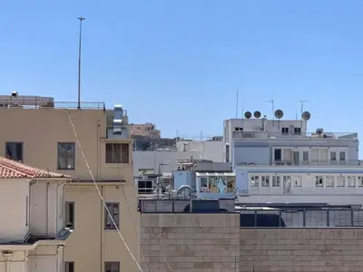 a view of a city with buildings at Pericles Penthouse *Parthenon View* Center in Athens