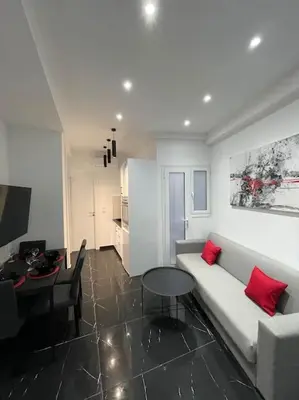 a living room with a white couch and a table at ATH-Brand new 2bedroom apartment in Athens