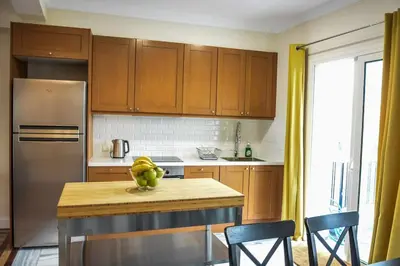 a kitchen with a table with a bowl of fruit on it at The Parthenon Terrace ReNoVaTeD with a view ! in Athens