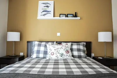 a bedroom with a bed with two lamps and two pillows at The Parthenon Terrace ReNoVaTeD with a view ! in Athens