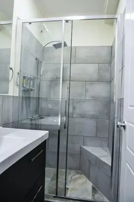 a bathroom with a shower and a sink at The Parthenon Terrace ReNoVaTeD with a view ! in Athens