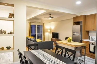 a kitchen and living room with a table and chairs at The Parthenon Terrace ReNoVaTeD with a view ! in Athens